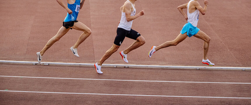 Chelyabinsk, Russia - June 4, 2022: group runners in spikes shoes Nike running middle distance at stadium during UFD Athletics Championship