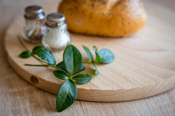 Homemade Poppy Seed Bread for Easter Blessing Basket on Wooden Cutting Board with Salt and Pepper Shakers and Butter Dish. Traditional Polish Easter basket preparation before church blessing.