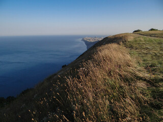 beautiful view from the hills to the sea with the city in the distance