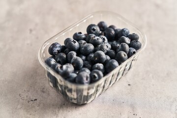  Delicious group of blueberries on plastic box marble surface