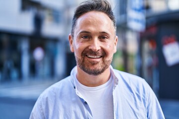 Young caucasian man smiling confident standing at street