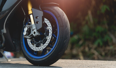 Close up of a motorcycle tire. motorcycle in a sunny motorbike on the road riding.with sunset light. copy space for your individual text.On the road. © PIPAT