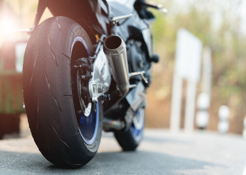 Close up of a motorcycle tire. motorcycle in a sunny motorbike on the road riding.with sunset light. copy space for your individual text.On the road.