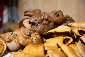 Spanish snacks and street food, baked pie empanadilla with different filling on market in San-Sebastian, Spain