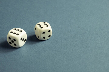 Random number generator. Two white dice with numerical values lie in a chaotic order.