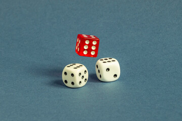 Random number generator. Red and white dice with numerical values lie in a chaotic order.