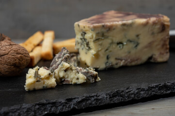 Cheese collection, blue stilton English cheese matured in red porto wine served as dessert with bread sticks