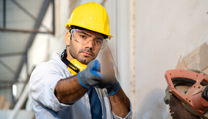 Male carpenter measuring and aiming plank for quality craft wood furniture in workshop. Craftsman uses timber to repair woodwork. Portrait of woodworker wears goggles angle lumber. Carpentry at work.