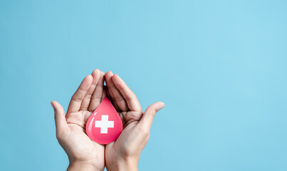 hands holding blood drop paper cut, blood transfusion, world blood donor day, red cross to give...