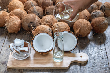 Virgin coconut oil liquid by cold pressed with HDL by Raw coconut milk in glass bottle.