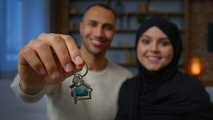 Happy owners property multiracial family spouses ethnic couple showing bunch of keys new home...