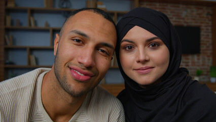 Spouses family multiracial diverse ethnicity couple man african american husband and arabian muslim woman wife smiling multiethnic girlfriend boyfriend posing together 30s happy homeowners portrait