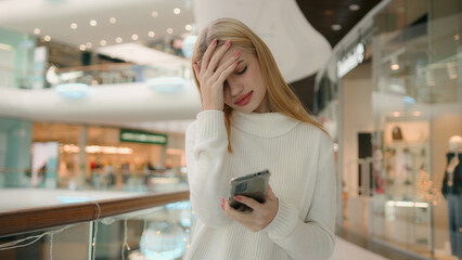 Sad Caucasian puzzled anxious female businesswoman 25s woman has problem with smartphone receive bad message on mobile phone low public internet connection upset dissatisfied girl lady express despair