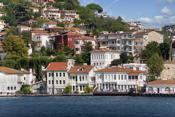 Fototapeta na wymiar View from Bosphorus strait of the green mountains of the Asian side, with traditional houses and dense trees in a summer day, Istanbul, Turkey