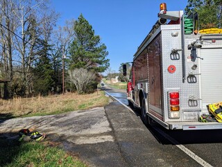 Fire engine parked on the road for a house fire.