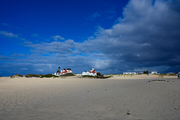 Fototapeta premium White sand, blue water and stormy clouds on La Concha beach, El Cotillo surfers village, Fuerteventura, Canary islands, Spain