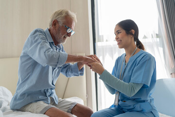 Fototapeta premium Female nurse caring for male elderly at home