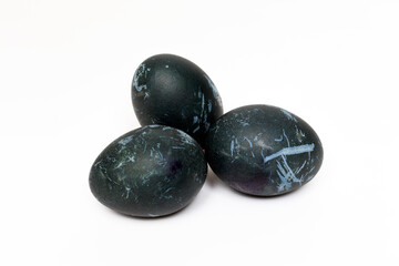 Easter blue eggs on a white background. Staining eggs with hibiscus tea, natural dyes