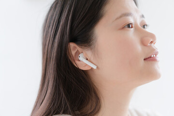 woman listen music in wireless earphones