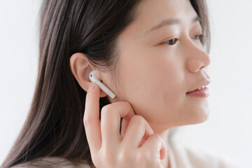 woman listen music in wireless earphones