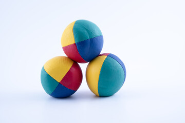 set of three brightly colored leather hand made and stitched professional juggling balls isolated on a white background
