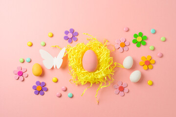 Easter holiday creative composition with easter eggs and decorations on pink background. Top view, flat lay