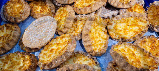Finnish traditional pasties or pirogs. Karelian pasties, Karelian pies or Karelian pirogs from region of Karelia. Homemade bread filled with rice porridge or cracked barley and have thin rye-crust. - obrazy, fototapety, plakaty