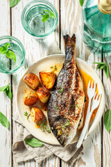 Roasted sea bream with cherry tomatoes and grilled potatoes