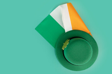saint patrick day background, green irish leprechaun hat with gold clover and irish flag, top view,...