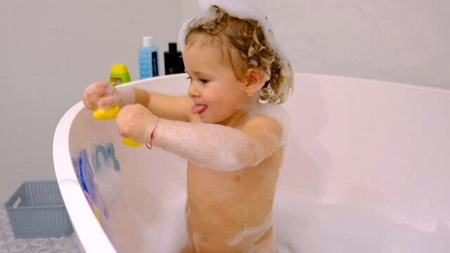 A child bathes in a bubble bath. Selective focus.