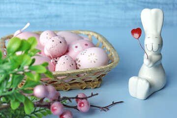 Decorative rabbits, lilies in cart of the valley and Easter eggs