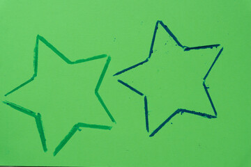 outline of stars on green paper