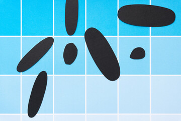 grungy, dirty black paper ovals on scrapbook paper sheet with paint-chip design (blue boxes)