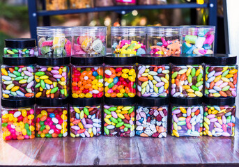 Many colorful candy and lollipops with gum in jars