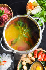 Korean spicy hot pot with beef meat and noodles on black background