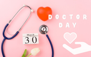 Doctor Day Concept, Above overhead of equipment medical red heart, doctor stethoscope and tulip flowers on pink background, care patient in hospital with copy space, Medical and Health care insurance