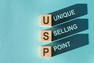 USP text on wooden blocks, financial business concept, blue background. USP - short for Unique...
