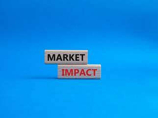 Market impact. Concept word Market impact on wooden cubes. Beautiful blue background. Business and Market impact concept. Copy space.