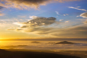 mountain peaks visible through the clouds