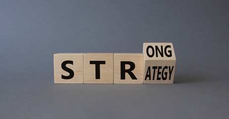 Strong Strategy symbol. Turned wooden cubes with words Strong Strategy. Beautiful grey background. Business and Strong Strategy concept. Copy space