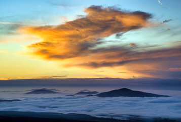 mountain peaks visible through the clouds
