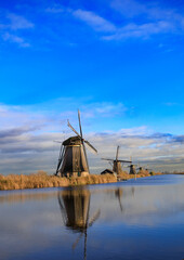 beautiful inspirational landscape with windmills in Kinderdijk, Netherlands at sunset. Fascinating places, tourist attraction. © Marcin