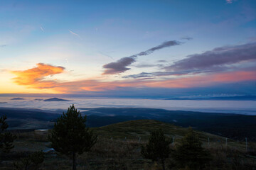 mountain peaks visible through the clouds
