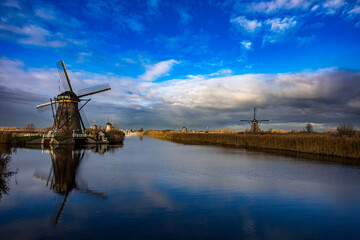 beautiful inspirational landscape with windmills in Kinderdijk, Netherlands at sunset. Fascinating places, tourist attraction. - obrazy, fototapety, plakaty