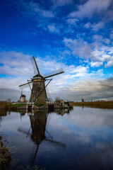 beautiful inspirational landscape with windmills in Kinderdijk, Netherlands at sunset. Fascinating places, tourist attraction. © Marcin