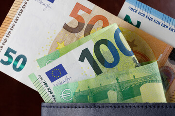 Euro bills notes almost fell out of the wallet