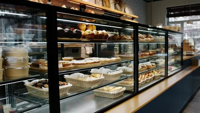 Counter full of delicious buns and pastries in a shop bakery