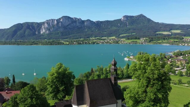 aerial view of mondsee with mountain drachenwand,pilgrimage church maria hilf,region salzkammergut,travel photography by drone,