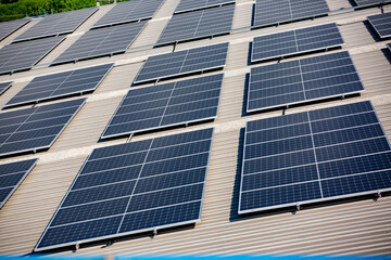 Solar panels on factory roof photovoltaic solar panels absorb sunlight as a source of energy to...