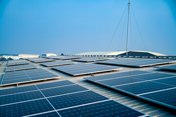 Solar panels on factory roof photovoltaic solar panels absorb sunlight as a source of energy to...